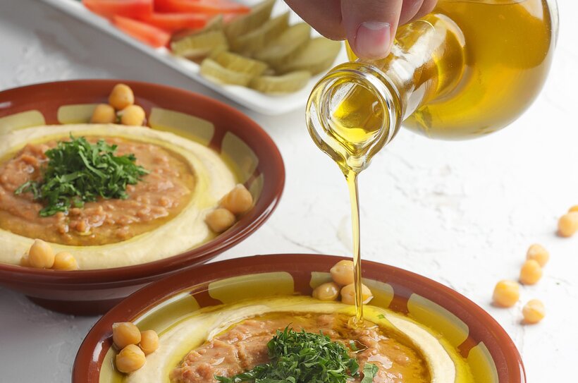 adding reference oil to a plate of hummus